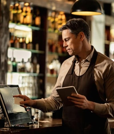 Restaurant manager reviewing financing options digitally