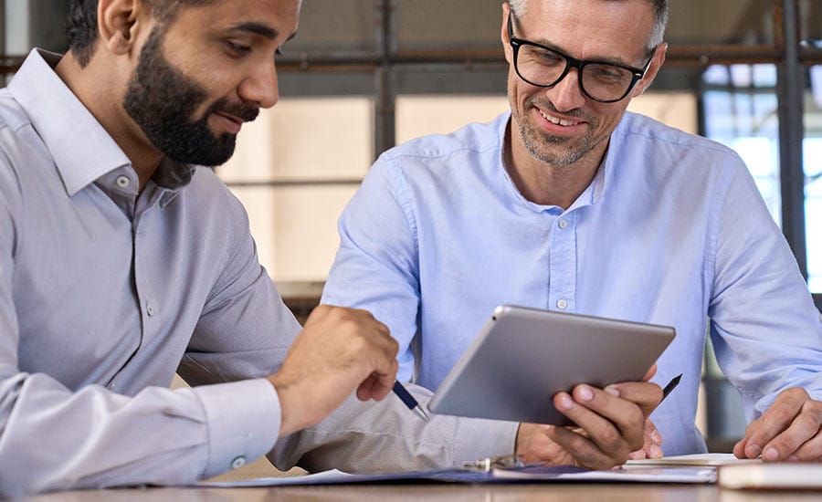 two-men-looking-at-tablet​