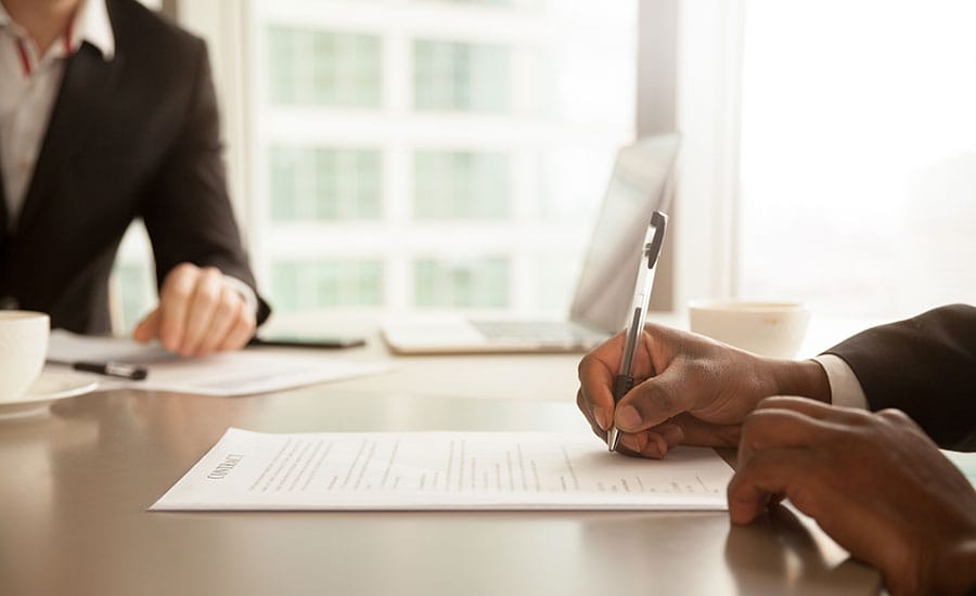 A person signing a document​