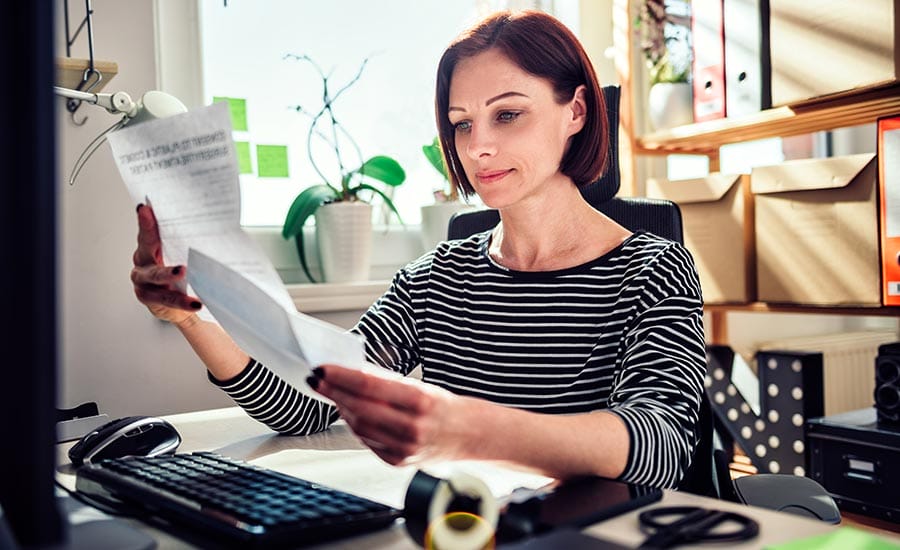 a woman is reading an official letter